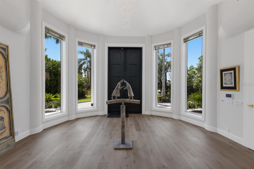 691 Eagle Watch Lane Osprey, FL 34229 - Photo 11 of 100 a view of a livingroom with furniture wooden floor and a window