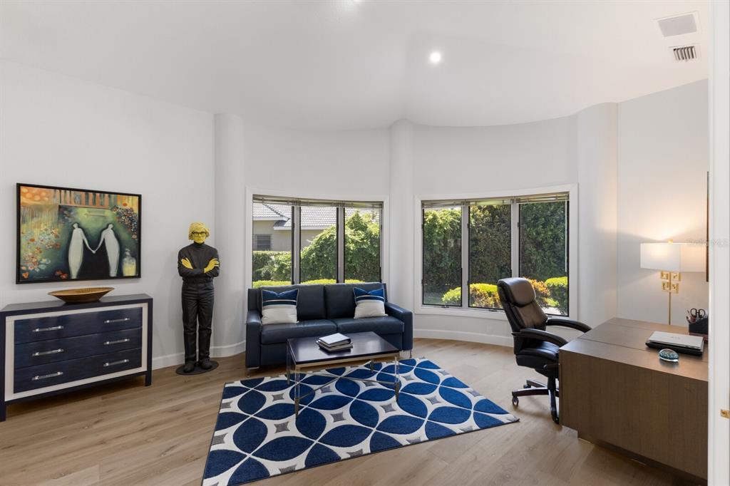 691 Eagle Watch Lane Osprey, FL 34229 - Photo 17 of 100 a living room with furniture and a flat screen tv
