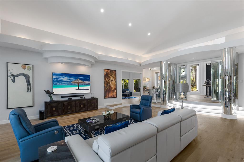 691 Eagle Watch Lane Osprey, FL 34229 - Photo 22 of 100 a living room with furniture and a flat screen tv