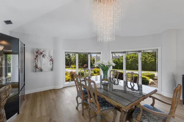 a kitchen with stainless steel appliances a dining table and chairs