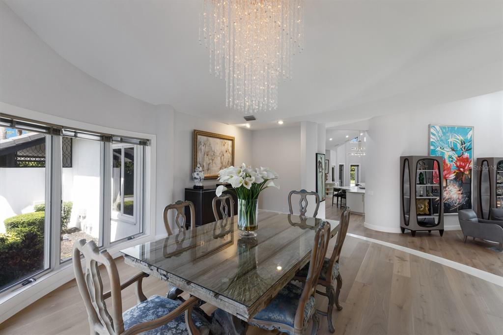 691 Eagle Watch Lane Osprey, FL 34229 - Photo 26 of 100 a dining room with furniture window and wooden floor
