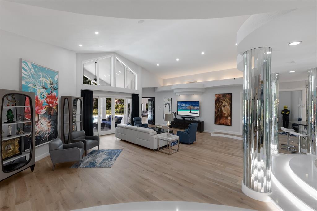 691 Eagle Watch Lane Osprey, FL 34229 - Photo 28 of 100 a living room with furniture or couch and a fireplace