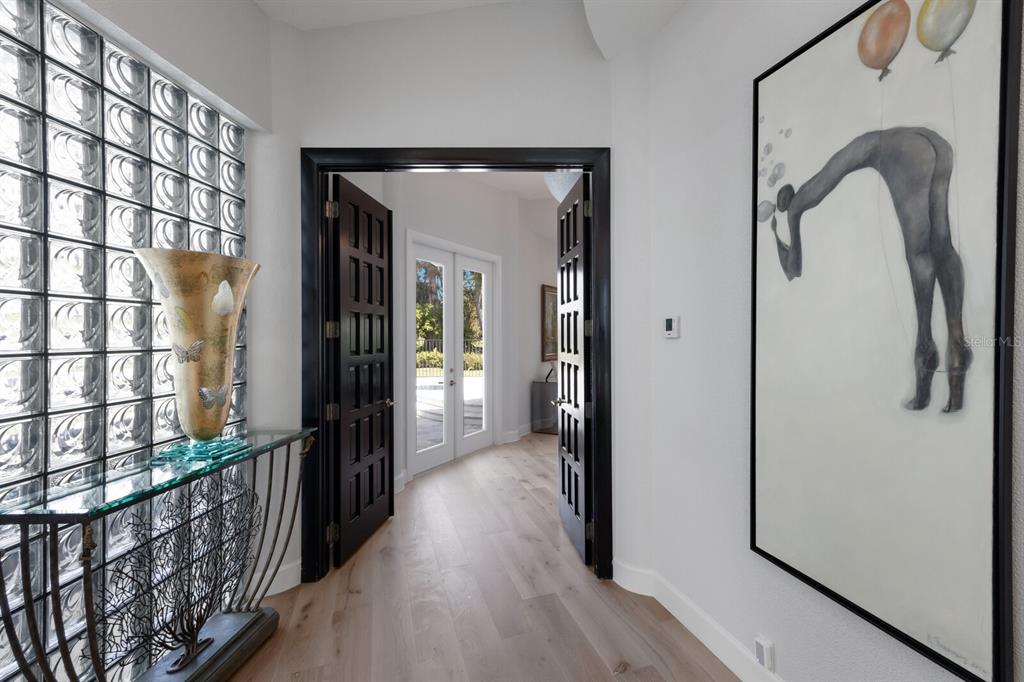 691 Eagle Watch Lane Osprey, FL 34229 - Photo 30 of 100 a view of a entryway door with wooden floor