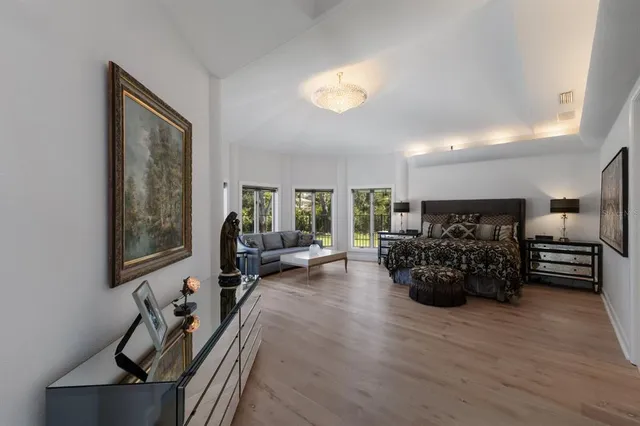 a living room with furniture kitchen view and a large window