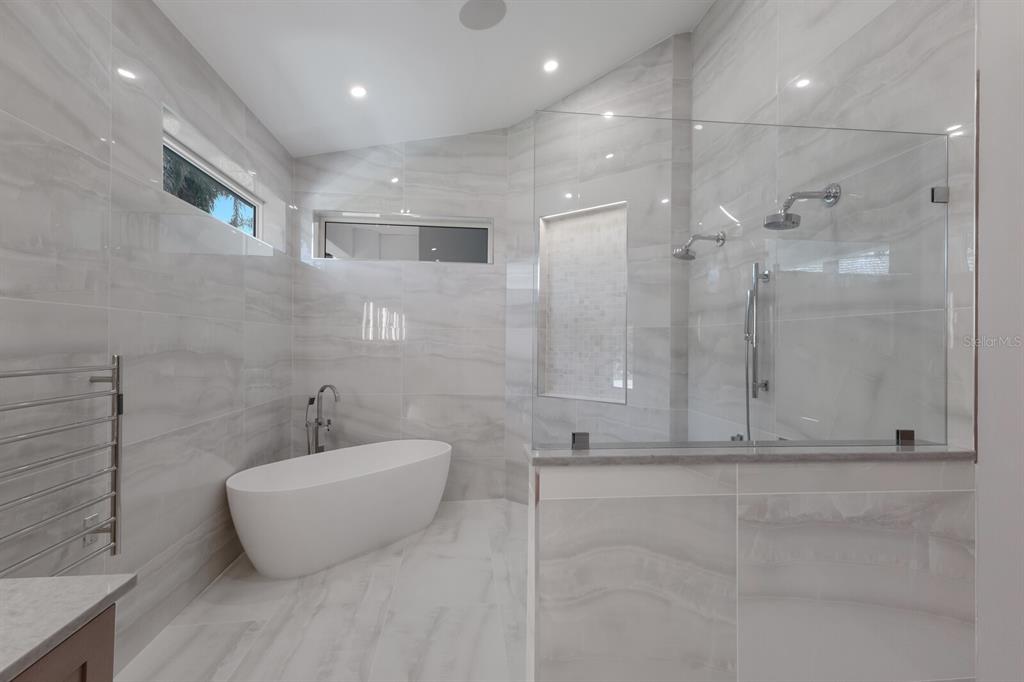 691 Eagle Watch Lane Osprey, FL 34229 - Photo 39 of 100 a bathroom with a shower and a tub