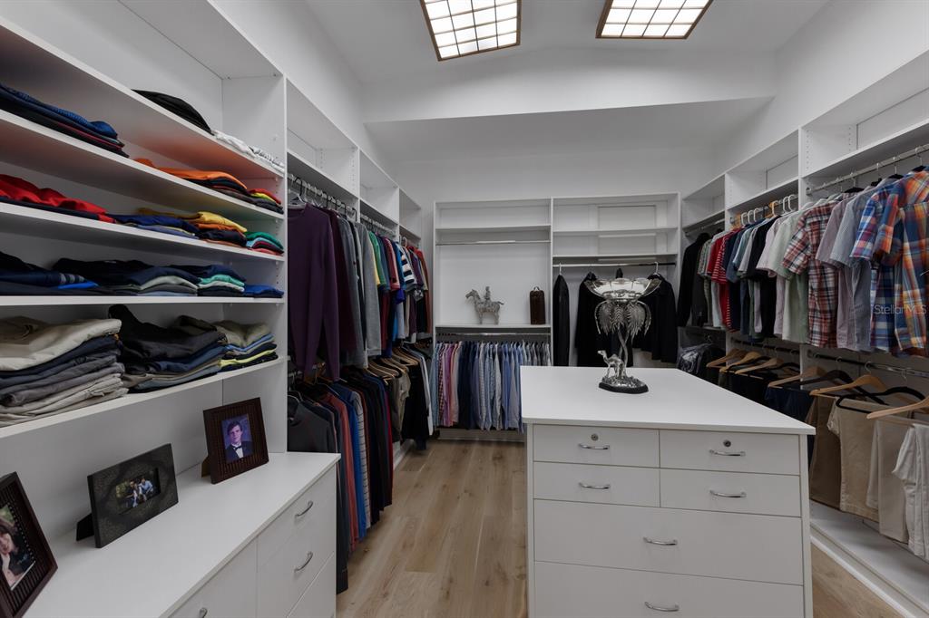 691 Eagle Watch Lane Osprey, FL 34229 - Photo 42 of 100 a view of walk in closet with clothes and shoes