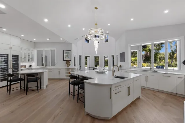 an aerial view of residential houses with outdoor space and swimming pool