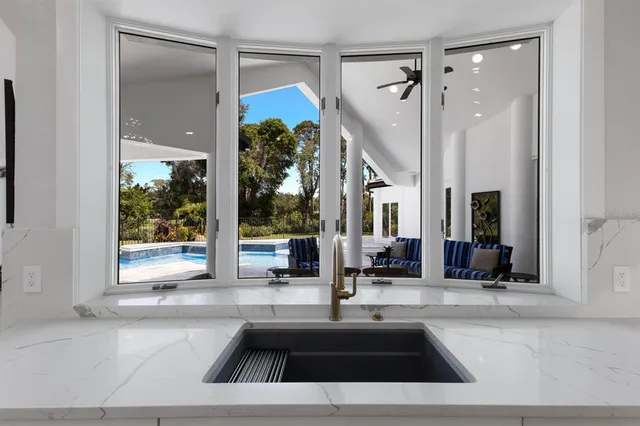 an aerial view of a house with outdoor space and lake view