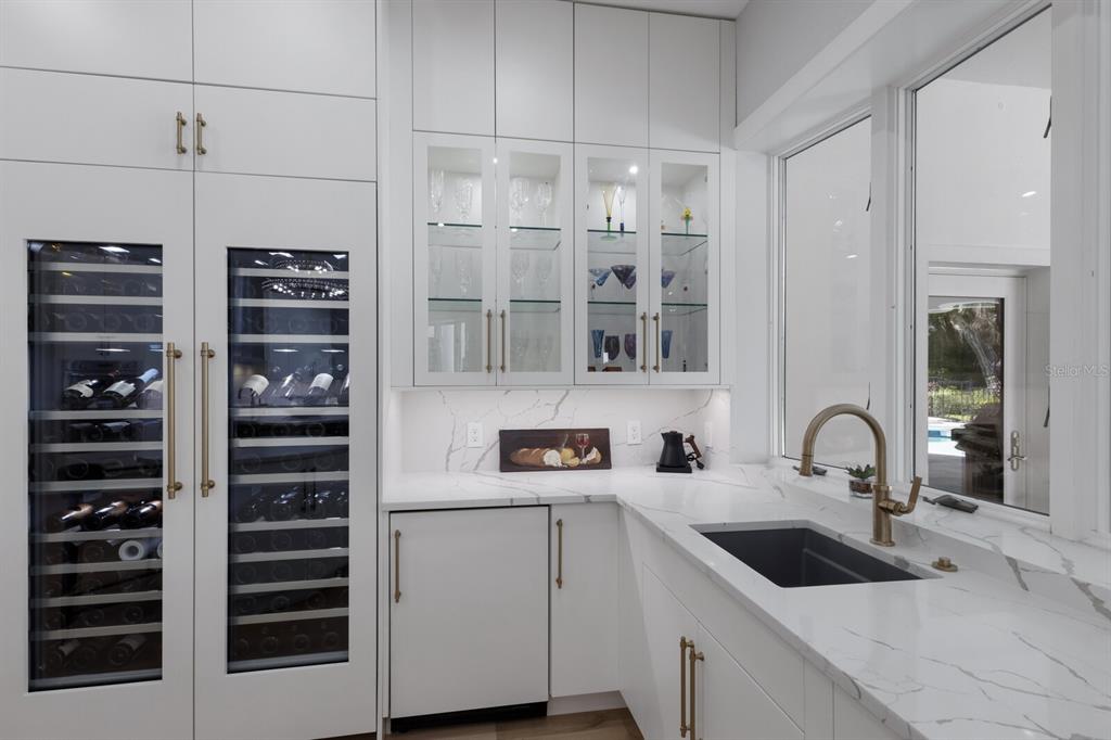 691 Eagle Watch Lane Osprey, FL 34229 - Photo 53 of 100 a kitchen with a sink and cabinets
