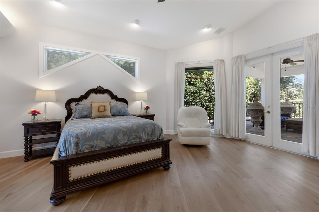 691 Eagle Watch Lane Osprey, FL 34229 - Photo 66 of 100 a bedroom with a bed and wooden floor