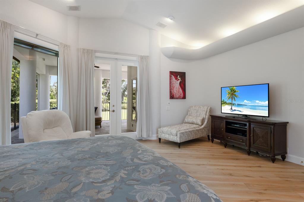 691 Eagle Watch Lane Osprey, FL 34229 - Photo 67 of 100 a living room with furniture and a flat screen tv