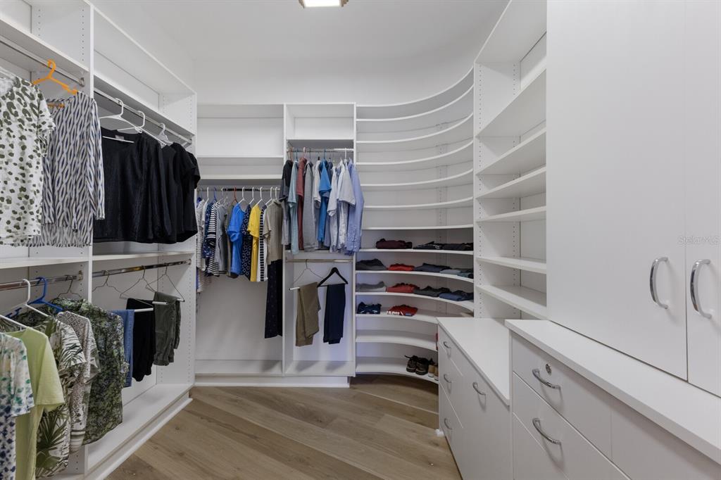 691 Eagle Watch Lane Osprey, FL 34229 - Photo 69 of 100 a view of walk in closet with clothes and shoes