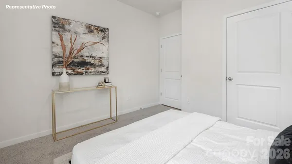a bedroom with a bed and a white cabinet