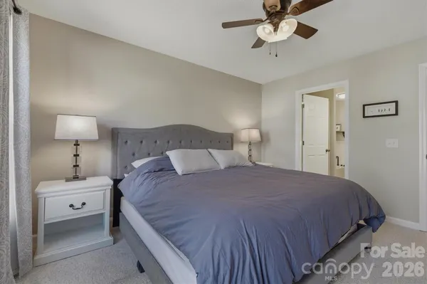 a bedroom with a bed and a lamp