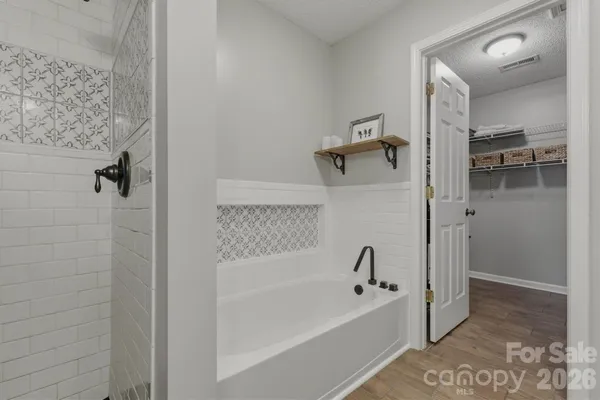 a bathroom with a bathtub and shower