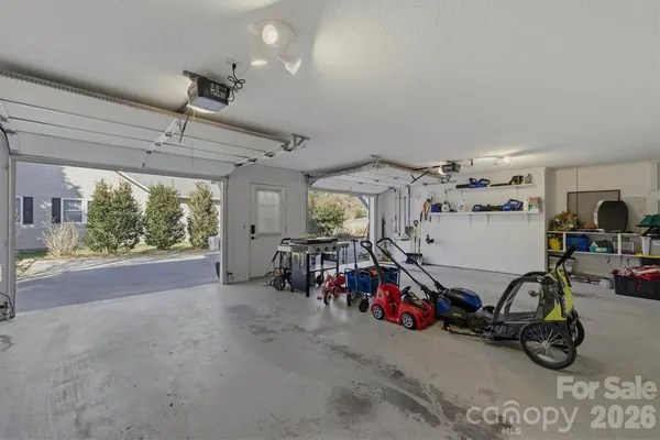 a view of a garage with a bike and car