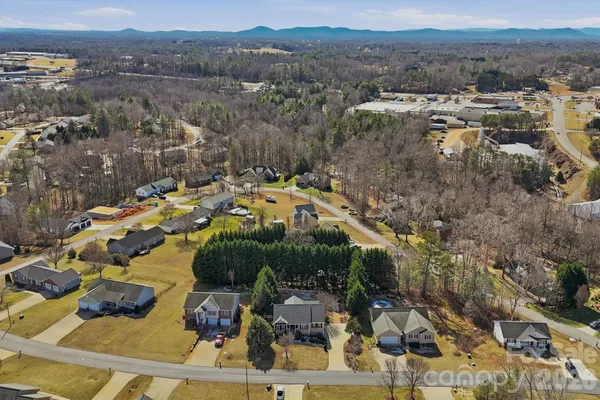 an aerial view of a house with a yard and garden