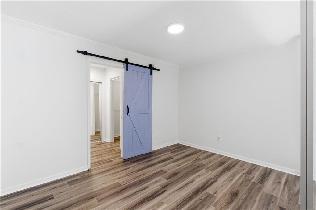 1150 Collier Road Northwest, Unit 24K Atlanta, GA 30318 - Photo 12 of 22 a view of empty room with wooden floor