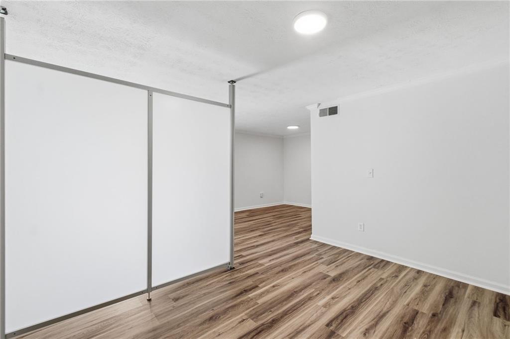 1150 Collier Road Northwest, Unit 24K Atlanta, GA 30318 - Photo 13 of 22 a view of a room with wooden floor