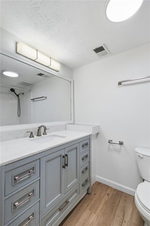 1150 Collier Road Northwest, Unit 24K Atlanta, GA 30318 - Photo 14 of 22 a spacious bathroom with a granite countertop sink mirror and toilet