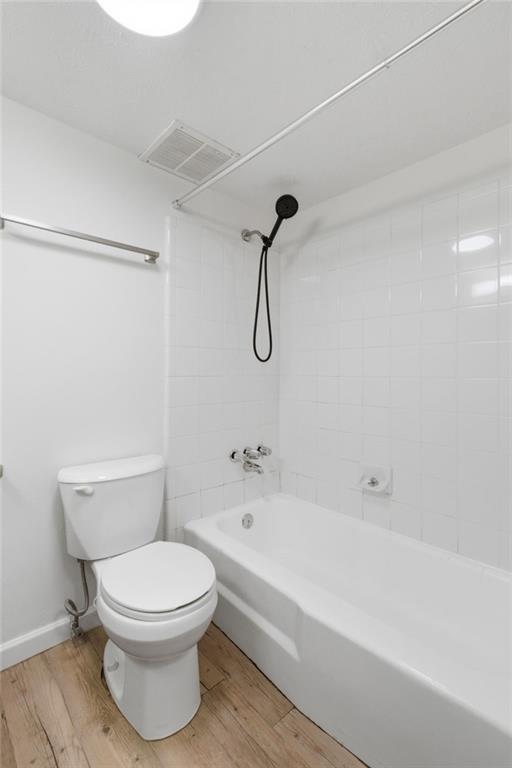 1150 Collier Road Northwest, Unit 24K Atlanta, GA 30318 - Photo 15 of 22 a bathroom with a toilet and a shower