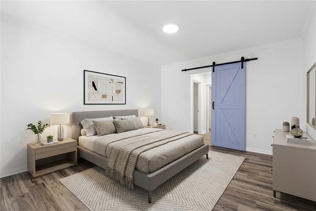 1150 Collier Road Northwest, Unit 24K Atlanta, GA 30318 - Photo 17 of 22 a bedroom with a bed and a table