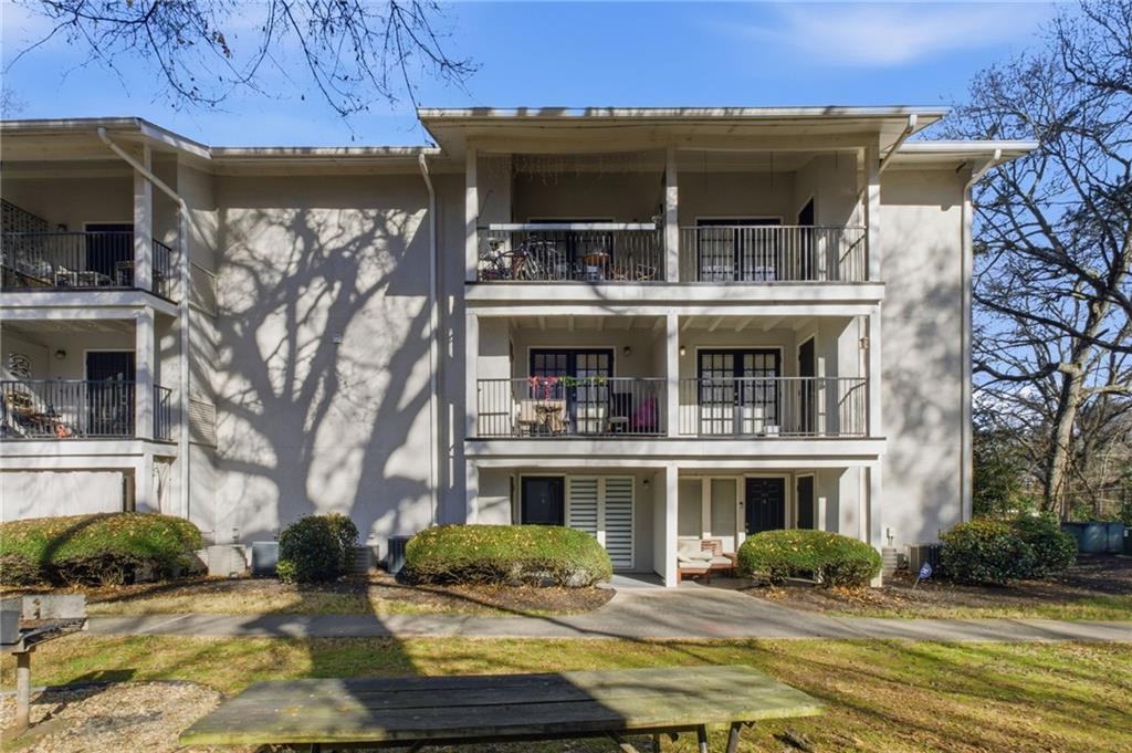 1150 Collier Road Northwest, Unit 24K Atlanta, GA 30318 - Photo 19 of 22 a front view of a house with a yard