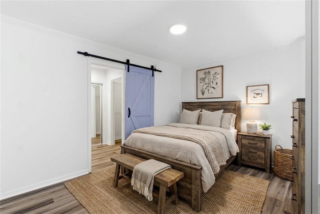 1150 Collier Road Northwest, Unit 24K Atlanta, GA 30318 - Photo 22 of 22 a bed room with a bed and a night stand