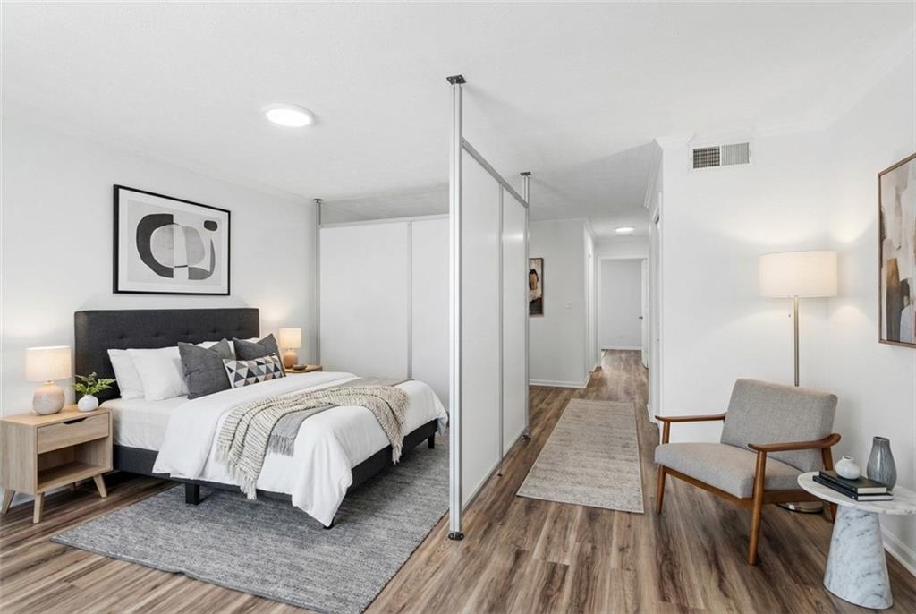 1150 Collier Road Northwest, Unit 24K Atlanta, GA 30318 - Photo 10 of 22 a bedroom with a bed and a table