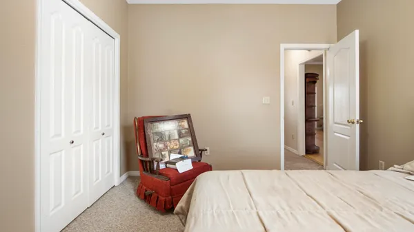 a bedroom with a bed and a mirror