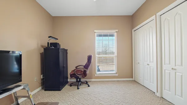 a view of a livingroom with workspace and a window