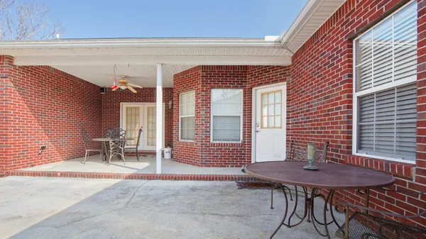 a backyard of a house with table and chairs