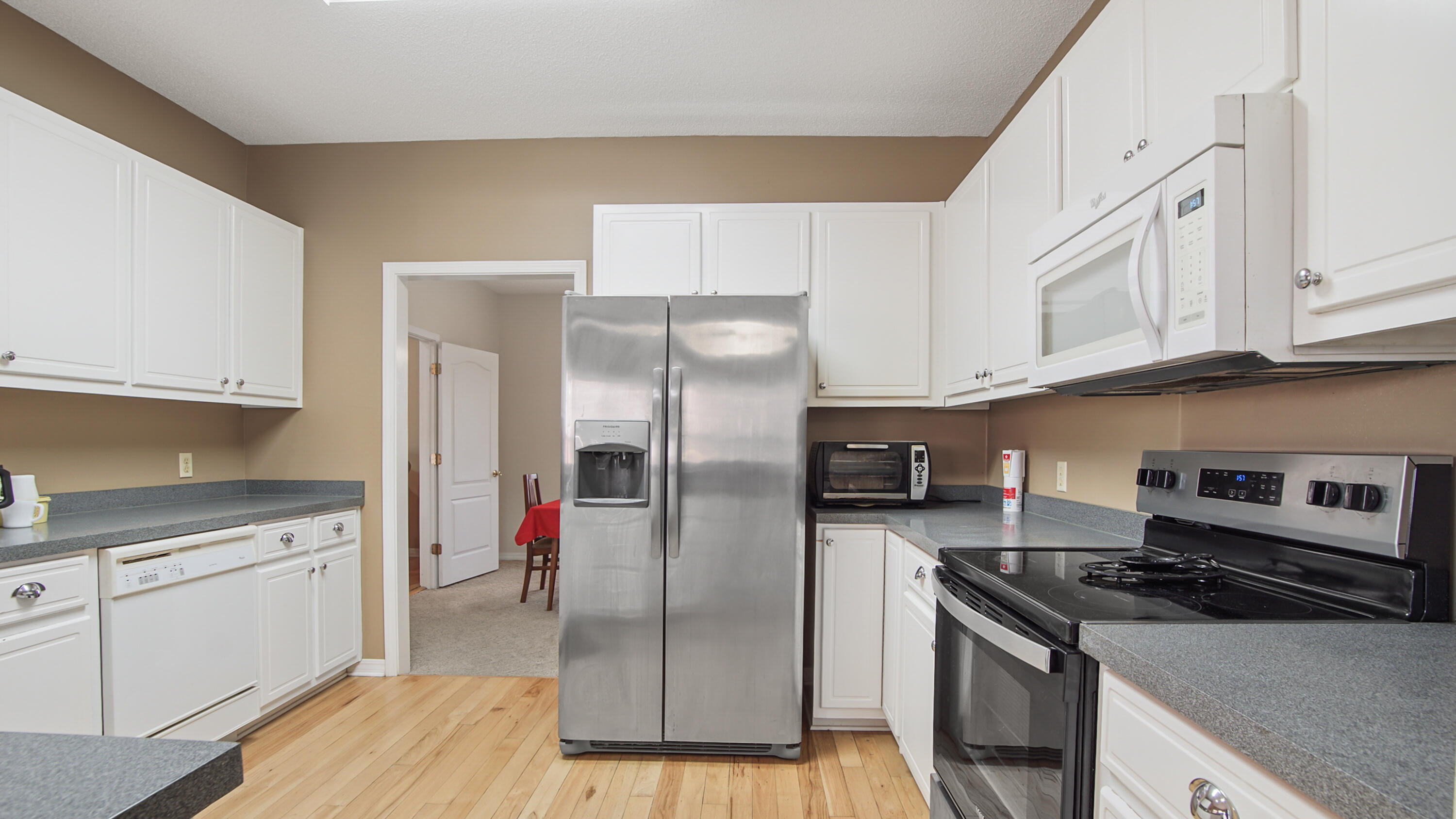 1333 Parrish Road Florala, AL 36442 - Photo 5 of 48 a kitchen with stainless steel appliances granite countertop a stove refrigerator and cabinets