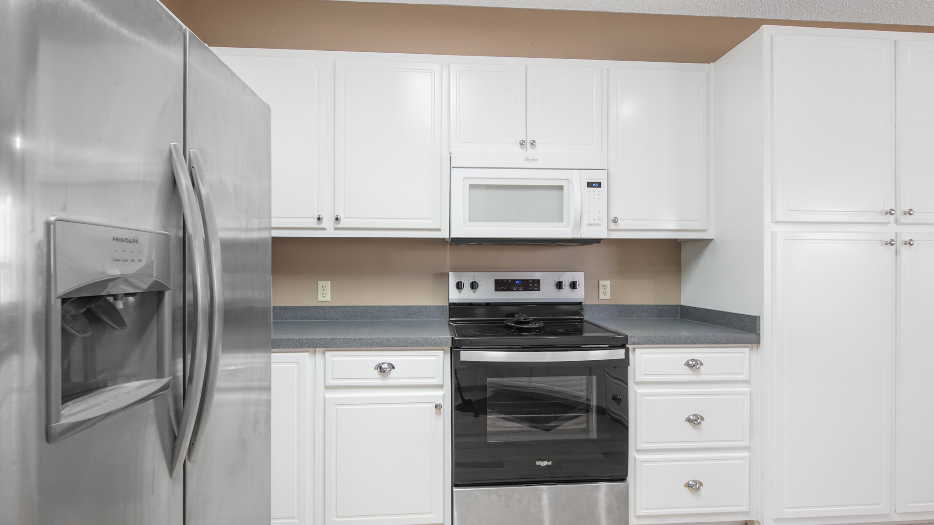 1333 Parrish Road Florala, AL 36442 - Photo 6 of 48 a kitchen with granite countertop white cabinets and stainless steel appliances