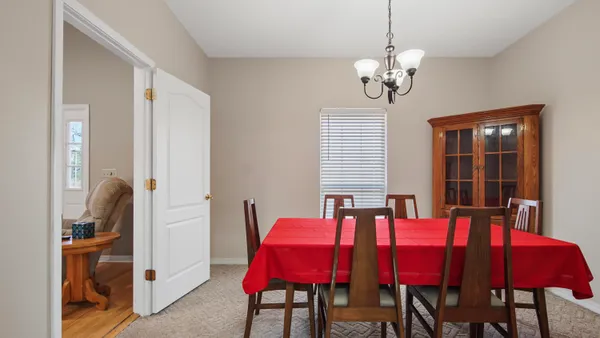 a view of a dining room with furniture and chandelier