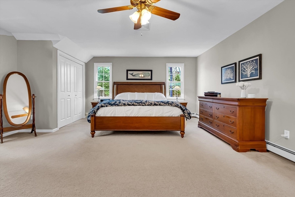 9 Juniper Road Upton, MA 01568 - Photo 27 of 42 a bedroom with a bed lamp and dresser