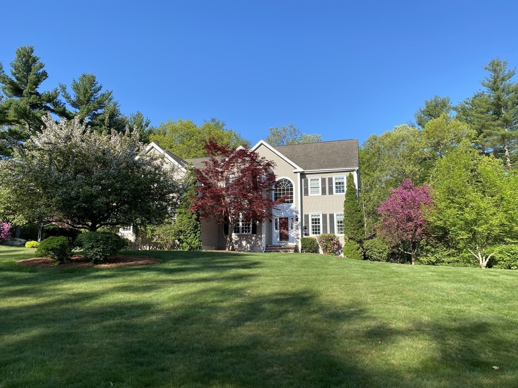 9 Juniper Road Upton, MA 01568 - Photo 39 of 42 a view of a white house with a big yard and potted plants and large trees