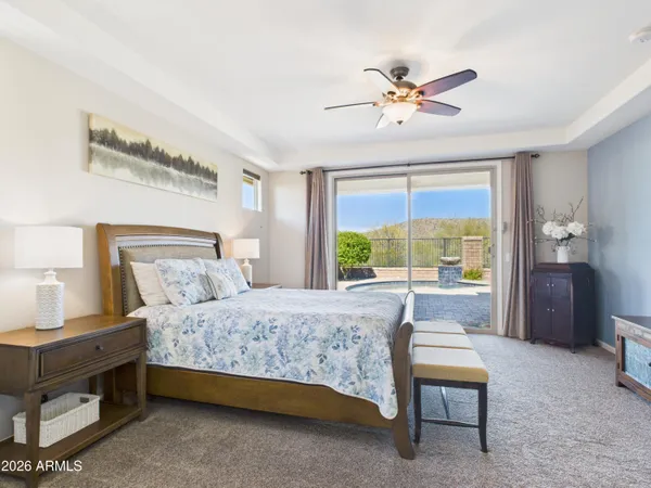 a bedroom with a bed and a chandelier