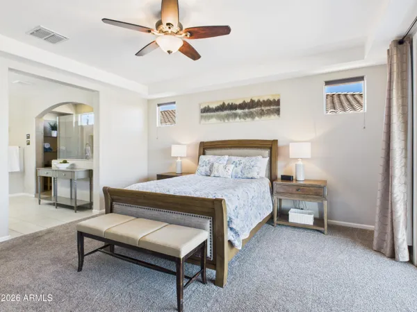 a bedroom with a bed a table and painting