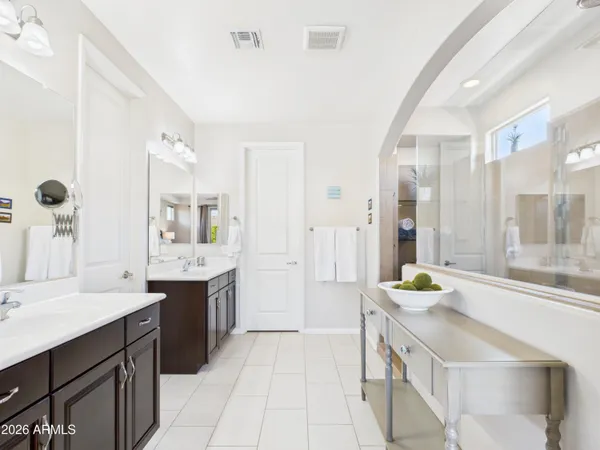 a spacious bathroom with a granite countertop sink and a bathtub