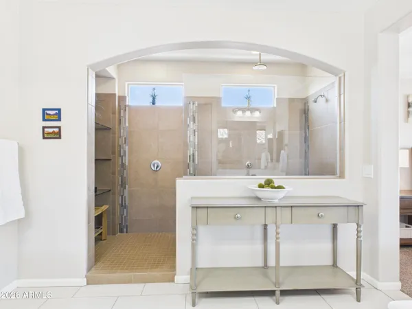 a bathroom with a sink a mirror a window and glass door