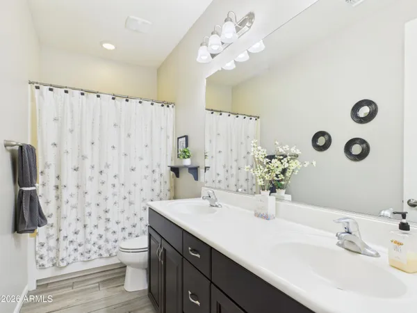 a bathroom with a double vanity sink mirror and toilet
