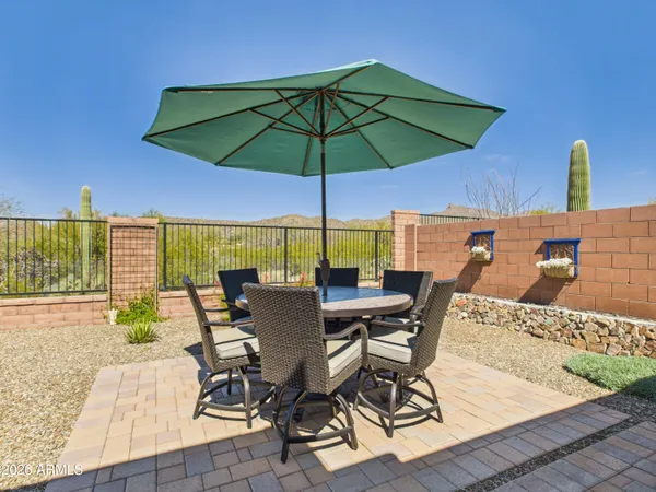 a view of an outdoor space with furniture and umbrella