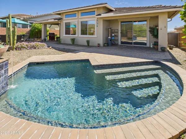 a swimming pool view with a outdoor seating