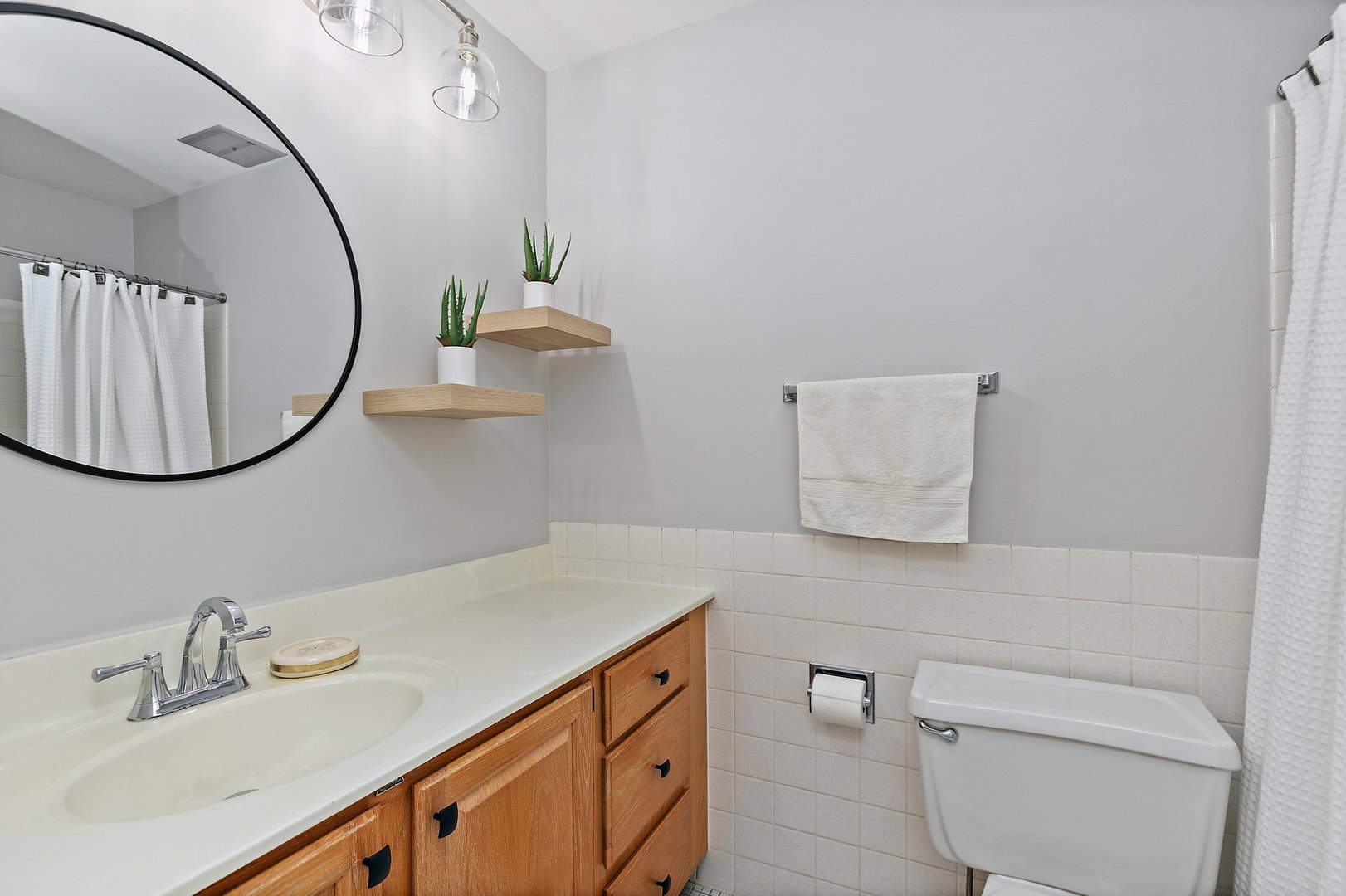 1207 South Old Wilke Road, Unit 409 Rolling Meadows, IL 60005 - Photo 11 of 26 a bathroom with a sink mirror and vanity