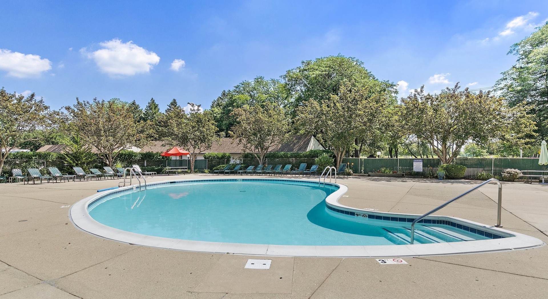 1207 South Old Wilke Road, Unit 409 Rolling Meadows, IL 60005 - Photo 17 of 26 a view of a swimming pool with a yard and plants