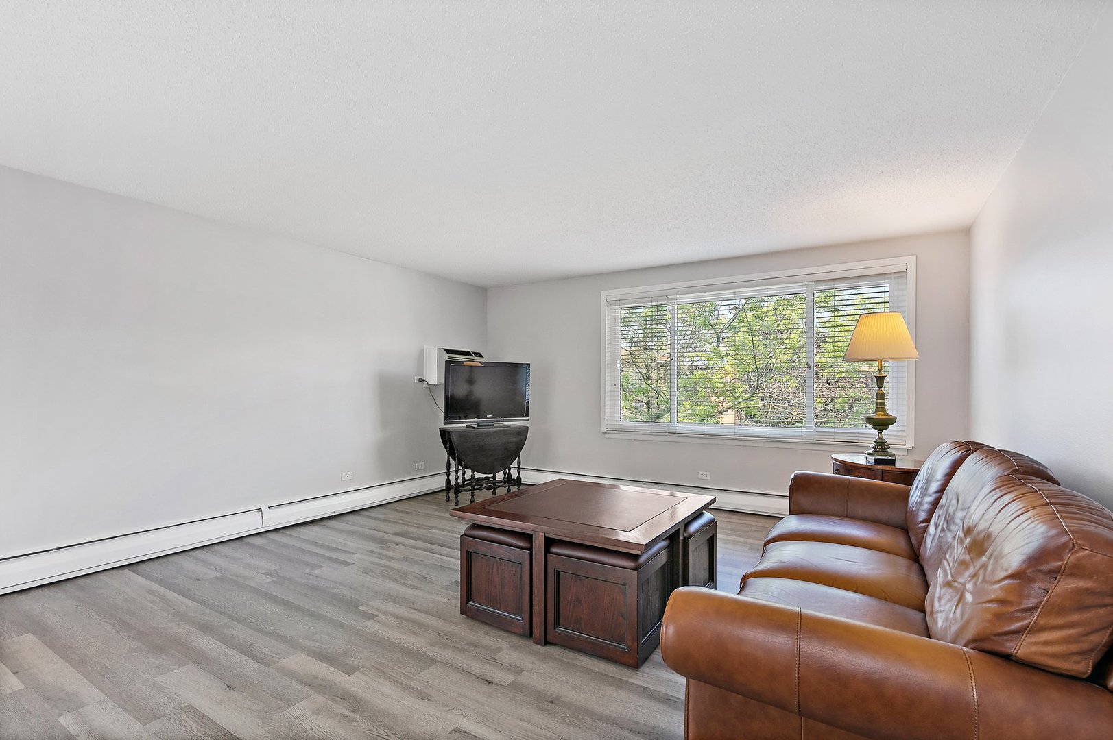 1207 South Old Wilke Road, Unit 409 Rolling Meadows, IL 60005 - Photo 2 of 26 a living room with furniture and a window
