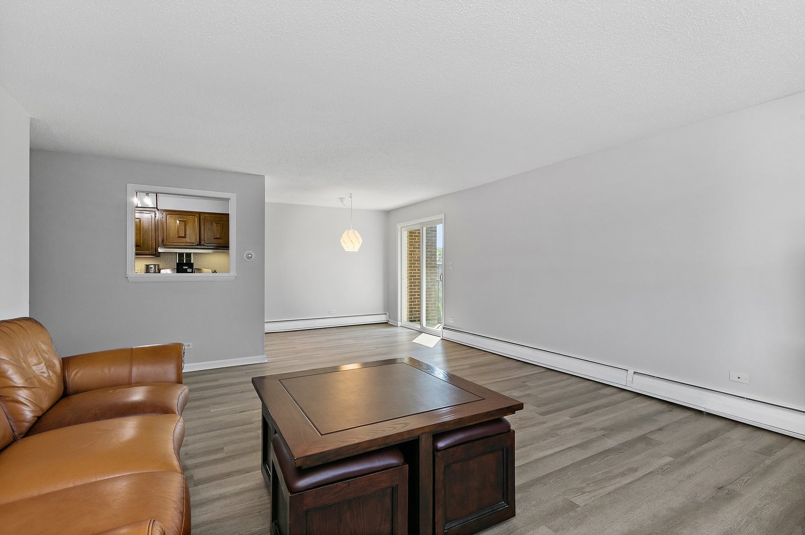 1207 South Old Wilke Road, Unit 409 Rolling Meadows, IL 60005 - Photo 3 of 26 a living room with furniture and a wooden floor