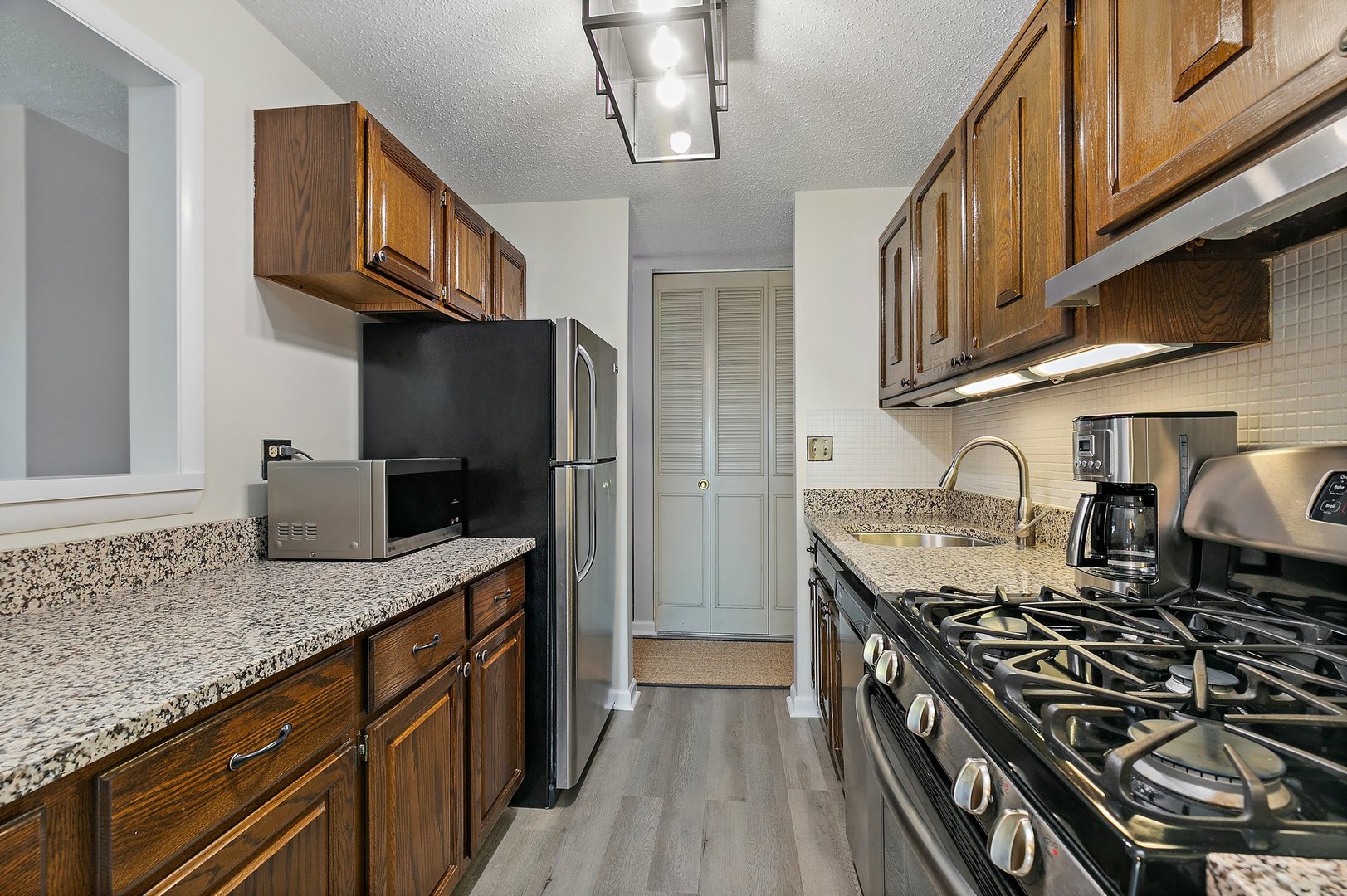 1207 South Old Wilke Road, Unit 409 Rolling Meadows, IL 60005 - Photo 5 of 26 a kitchen with stainless steel appliances granite countertop a stove and a sink
