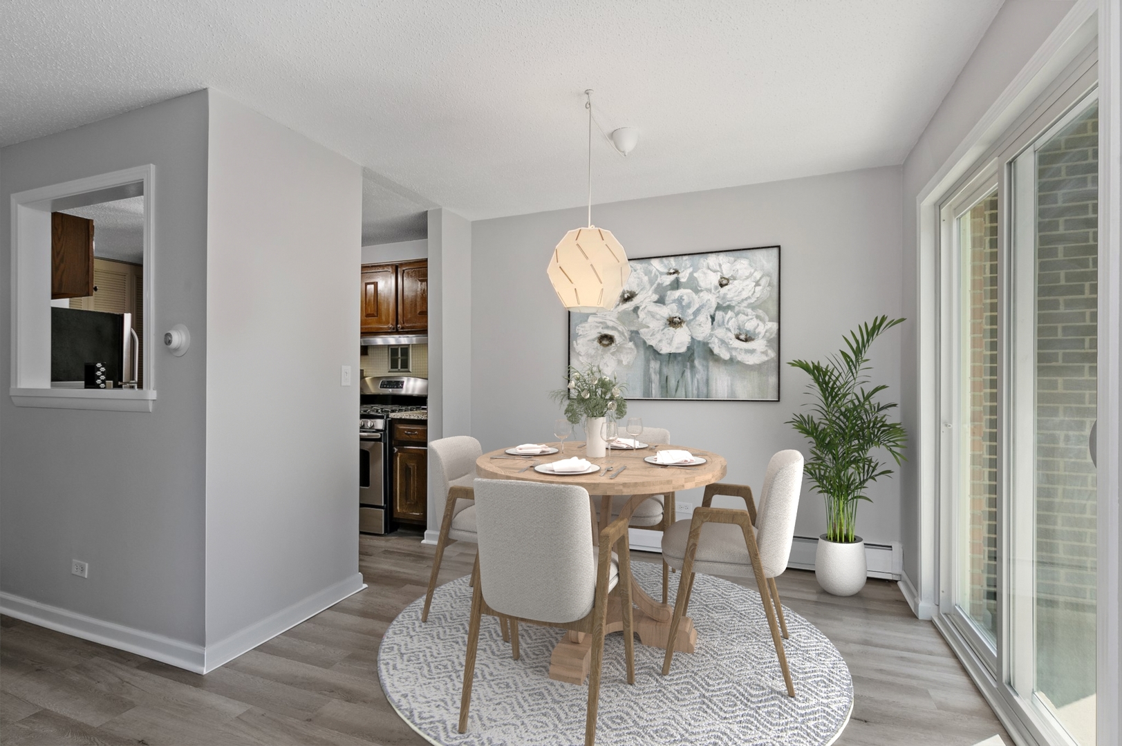 1207 South Old Wilke Road, Unit 409 Rolling Meadows, IL 60005 - Photo 6 of 26 a dining room with furniture potted plants and wooden floor